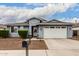 Single-story home with gray exterior, two-car garage, and well-manicured landscaping at 8938 N 15Th Ln, Phoenix, AZ 85021