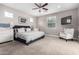 Spacious main bedroom with a large bed, comfy chair, and plenty of natural light at 8938 N 15Th Ln, Phoenix, AZ 85021