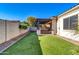Artificial turf backyard with hot tub and pergola at 10141 E Stealth Ave, Mesa, AZ 85212