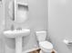 Small bathroom with pedestal sink and toilet at 10141 E Stealth Ave, Mesa, AZ 85212