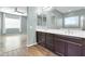Double vanity bathroom with dark brown cabinets at 10141 E Stealth Ave, Mesa, AZ 85212