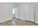 Bedroom with wood-look floors and mirrored closet doors at 10141 E Stealth Ave, Mesa, AZ 85212