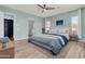 Primary bedroom featuring a ceiling fan, soft blue walls, and a full ensuite bathroom at 10141 E Stealth Ave, Mesa, AZ 85212