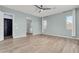 Spacious bedroom with wood-look floors and ceiling fan at 10141 E Stealth Ave, Mesa, AZ 85212