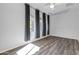 Spacious bedroom featuring stylish wood-look floors, a ceiling fan, and abundant natural light at 10141 E Stealth Ave, Mesa, AZ 85212