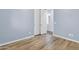 Light blue bedroom with wood-look floors and double doors at 10141 E Stealth Ave, Mesa, AZ 85212