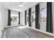 Sunlit bedroom featuring stylish wood-look floors, a ceiling fan, and three large windows at 10141 E Stealth Ave, Mesa, AZ 85212