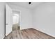 A bright bedroom with wood flooring and an open doorway to another room at 10141 E Stealth Ave, Mesa, AZ 85212