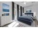 Relaxing bedroom with a stylish blue bed, ample natural light, and a cozy ambiance at 10141 E Stealth Ave, Mesa, AZ 85212