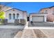 Beautiful stucco home with a 2-car garage and well-manicured landscaping at 10141 E Stealth Ave, Mesa, AZ 85212