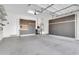 Garage with built-in storage cabinets and epoxy flooring at 10141 E Stealth Ave, Mesa, AZ 85212