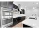 Modern kitchen with stainless steel appliances, white countertops, and plenty of cabinet space at 10141 E Stealth Ave, Mesa, AZ 85212