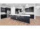 Spacious kitchen with stainless steel appliances, a center island, and dark cabinets at 10141 E Stealth Ave, Mesa, AZ 85212