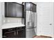 Kitchen with stainless steel appliances, white backsplash and quartz countertops at 10141 E Stealth Ave, Mesa, AZ 85212