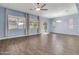 Spacious living area with wood-look tile flooring and a ceiling fan at 10141 E Stealth Ave, Mesa, AZ 85212