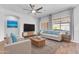 Comfortable living room features a sofa, armchairs, modern TV, and stylish decor at 10141 E Stealth Ave, Mesa, AZ 85212