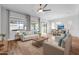 Bright living room with neutral furniture, large windows, and an adjacent dining area at 10141 E Stealth Ave, Mesa, AZ 85212