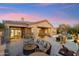 Outdoor patio with seating area, pool, and stunning sunset views at 10175 E Winter Sun Dr, Scottsdale, AZ 85262