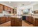 Spacious kitchen with wood cabinets, granite island, and stainless steel appliances at 10175 E Winter Sun Dr, Scottsdale, AZ 85262