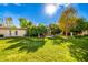 Spacious backyard with grassy lawn and mature trees offering shade at 10314 W Manzanita Dr, Sun City, AZ 85373