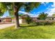 Landscaped yard with brick wall and mature trees at 10314 W Manzanita Dr, Sun City, AZ 85373
