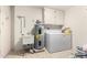 Functional laundry room, complete with washer, dryer, sink, and storage cabinets at 10314 W Manzanita Dr, Sun City, AZ 85373