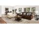 Bright living room with wood floors, leather couch and many windows providing natural light at 10314 W Manzanita Dr, Sun City, AZ 85373