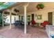 Covered patio features a table, chairs, and hanging flower baskets at 10314 W Manzanita Dr, Sun City, AZ 85373