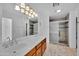 Elegant bathroom with double sinks, marble vanity, and shower at 10873 W Carlota Ln, Peoria, AZ 85373