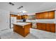 Kitchen features wood cabinets, granite countertops, and a kitchen island at 10873 W Carlota Ln, Peoria, AZ 85373