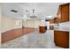 Open concept kitchen and dining area with hardwood floors and a chandelier at 10873 W Carlota Ln, Peoria, AZ 85373