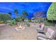 Landscaped backyard with fire pit and seating area at 12750 W Nogales Dr, Sun City West, AZ 85375