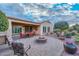 Outdoor patio with fire pit, seating area, and mature desert landscaping at 12750 W Nogales Dr, Sun City West, AZ 85375