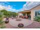 Inviting backyard patio with a fire pit, seating area, and landscaping at 12750 W Nogales Dr, Sun City West, AZ 85375