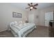 Cozy bedroom with a queen-size bed and ceiling fan at 12750 W Nogales Dr, Sun City West, AZ 85375