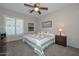 Charming bedroom with a queen-size bed and a ceiling fan at 12750 W Nogales Dr, Sun City West, AZ 85375