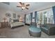 Relaxing Primary bedroom with two wicker armchairs and a ceiling fan at 12750 W Nogales Dr, Sun City West, AZ 85375