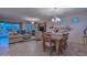 Bright dining room with a wood table and chairs, complemented by a chandelier and artwork at 12750 W Nogales Dr, Sun City West, AZ 85375