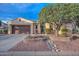 Tan one-story home with a brown door and two-car garage, nicely landscaped at 12750 W Nogales Dr, Sun City West, AZ 85375