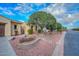 Landscaped front yard with a mature tree and stone pathway at 12750 W Nogales Dr, Sun City West, AZ 85375