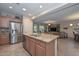 Kitchen features an island with seating and a view to living room at 12750 W Nogales Dr, Sun City West, AZ 85375
