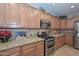 Spacious kitchen featuring granite countertops and stainless steel appliances at 12750 W Nogales Dr, Sun City West, AZ 85375