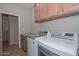 Laundry room with washer, dryer, and cabinets at 12750 W Nogales Dr, Sun City West, AZ 85375