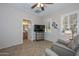 Bright living room with built-in entertainment center and access to bathroom at 12750 W Nogales Dr, Sun City West, AZ 85375