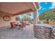 Covered patio with dining area and built-in grill at 12750 W Nogales Dr, Sun City West, AZ 85375