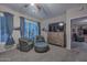 Secondary sitting area with two wicker armchairs, ottoman, and a wooden dresser at 12750 W Nogales Dr, Sun City West, AZ 85375