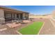 Landscaped backyard with putting green and patio at 16221 S 35Th Dr, Phoenix, AZ 85045