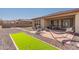 Landscaped backyard with putting green and patio at 16221 S 35Th Dr, Phoenix, AZ 85045