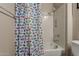 Simple bathroom with a shower/tub combo and fish-themed shower curtain at 16221 S 35Th Dr, Phoenix, AZ 85045