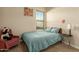Bright bedroom with a plush bed and an accent chair at 16221 S 35Th Dr, Phoenix, AZ 85045